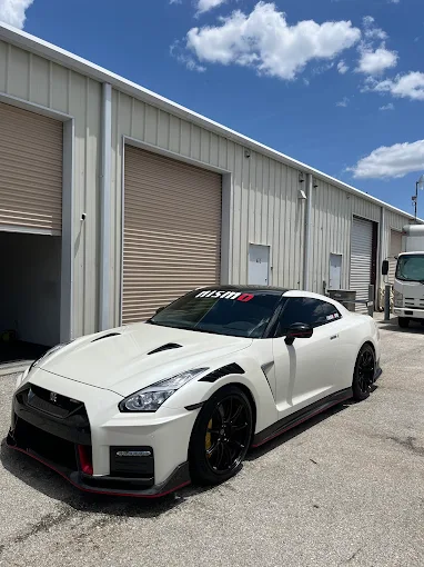White nissan GTR parked outside of a unit, after being recently detailed