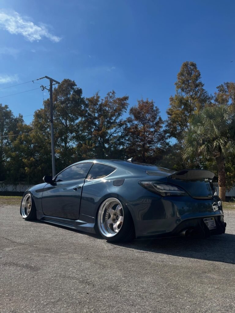 Genesis Coupe after enhancement polish, polished 3‑piece wheels, spray coating, and ceramic‑coated carbon fiber
